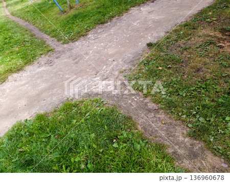 Earthen crossroads on the grass. 136960678