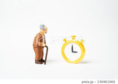 An elderly man and a gold watch. A celebration of age and life expectancy. Respect for longevity and milestone anniversary. Retirement honor and senior lifestyle 136961068