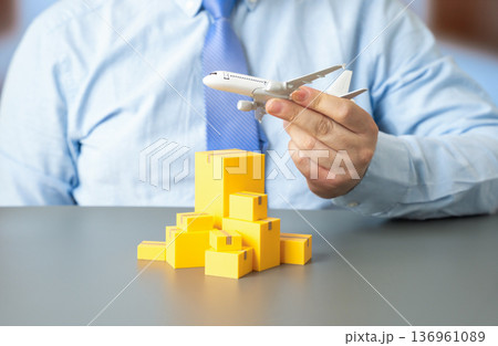 Airplane and boxes of goods. Air cargo transportation and express delivery logistics. Global freight services and international supply chain distribution Airplane and boxes of goods. Air cargo transportation and express delivery logistics. Global freight services and international supply chain distribution 136961089