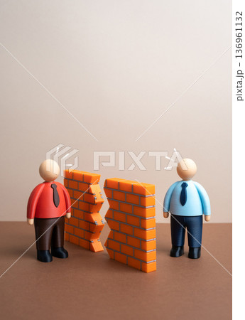 Breaking down the wall of misunderstanding between the parties and a chance to resolve the conflict. Reconciliation and open dialogue. Conflict resolution and partnership recovery concept. Breaking down the wall of misunderstanding between the parties and a chance to resolve the conflict. Reconciliation and open dialogue. Conflict resolution and partnership recovery concept. 136961132