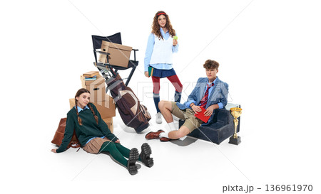 Teen students sitting with trophy and school props isolated on white. 136961970