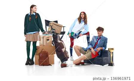 Teen students posing with boxes, golf bag and trophy isolated on white Teen students posing with boxes, golf bag and trophy isolated on white 136961971
