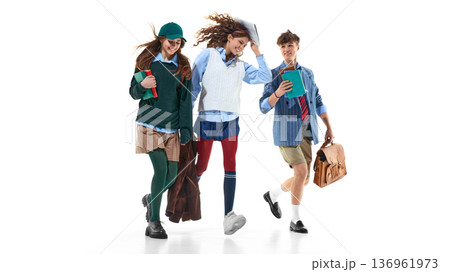 Three teen students running with books isolated on white. 136961973