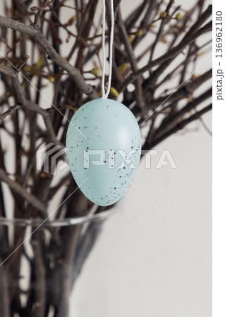 Close up of hanging Easter egg decoration on branches 136962180