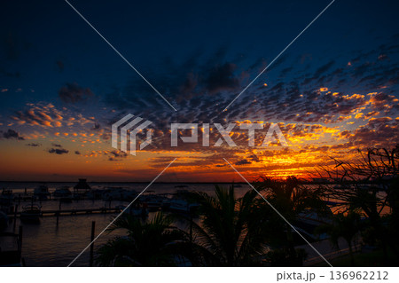Spectacular mexican sunset over marina with boats and palms Spectacular mexican sunset over marina with boats and palms 136962212