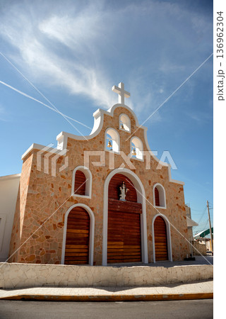 Colonial stone church with wooden doors in mexico town 136962304