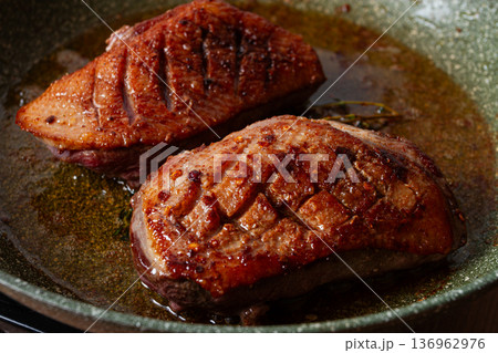 cooking duck breast, in a frying pan, fried, with spices and herbs, close-up, no people, cooking duck breast, in a frying pan, fried, with spices and herbs, close-up, no people, 136962976