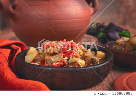 Chanakhi, a Georgian dish. in a clay pot, on a wooden table, stewed meat with vegetables, homemade, no people, Chanakhi, a Georgian dish. in a clay pot, on a wooden table, stewed meat with vegetables, homemade, no people, 136962993