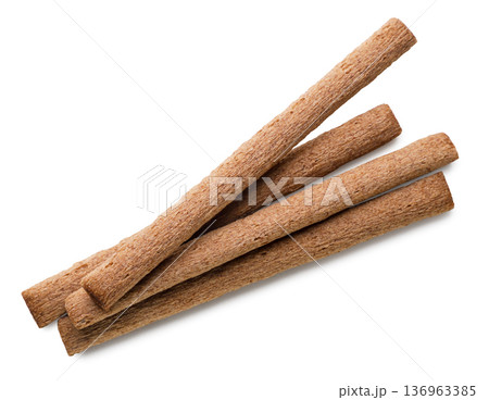 Chocolate wafer rolls on a white. Top view 136963385