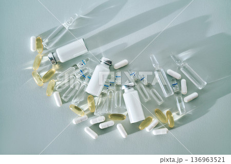 Medicine ampoules vials capsules on light blue background Medicine ampoules vials capsules on light blue background 136963521