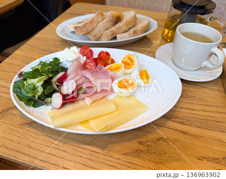 Breakfast plate with egg and ham slices. Protein nutrition, fresh ingredients and cafe meal concept. Breakfast plate with egg and ham slices. Protein nutrition, fresh ingredients and cafe meal concept. 136963902