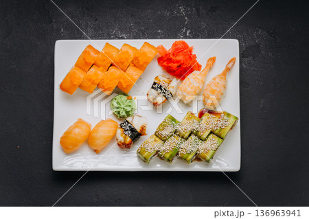 Assorted sushi set with rolls nigiri shrimp and soy sauce on restaurant plate Assorted sushi set with rolls nigiri shrimp and soy sauce on restaurant plate 136963941