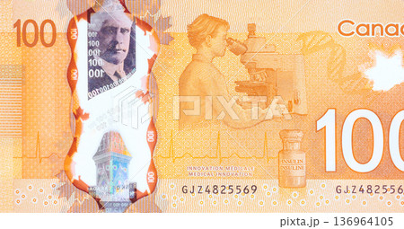 One hundred Canadian dollars in cash, Canadian currency money banknote from one business to another back side One hundred Canadian dollars in cash, Canadian currency money banknote from one business to another back side 136964105