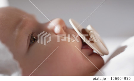 Cute Newborn Baby Girl Relaxing With Pacifier. Adorable Child Sucking Dummy. Cute Newborn Baby Girl Relaxing With Pacifier. Adorable Child Sucking Dummy. 136964950