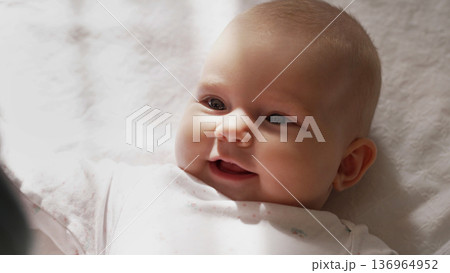Newborn Baby Girl Lying On White Blanket. Daughter Smiling, Cute Infant Child Newborn Baby Girl Lying On White Blanket. Daughter Smiling, Cute Infant Child 136964952