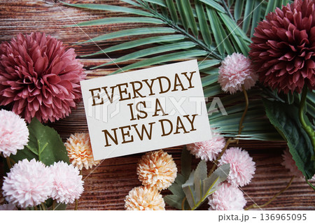 Everyday Is A New Day Motivational and Inspirational quotes with flowers bouquet decoration on wooen background Everyday Is A New Day Motivational and Inspirational quotes with flowers bouquet decoration on wooen background 136965095