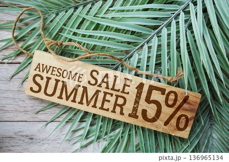 Awesome Summer Sale 15% off with green leaf on wooden background Awesome Summer Sale 15% off with green leaf on wooden background 136965134