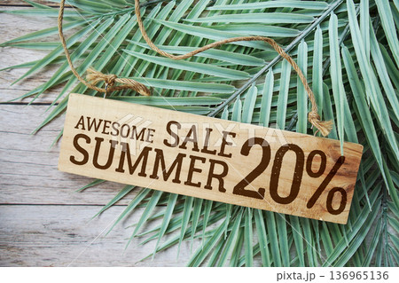 Awesome Summer Sale 20% off with green leaf on wooden background Awesome Summer Sale 20% off with green leaf on wooden background 136965136