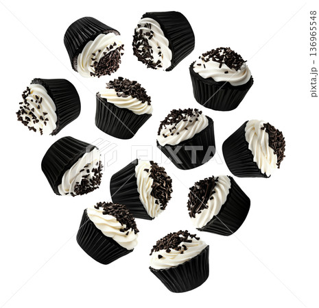 Chocolate cupcakes with vanilla frosting and chocolate isolated on white background, concept of dessert, sweets, and celebration 136965548