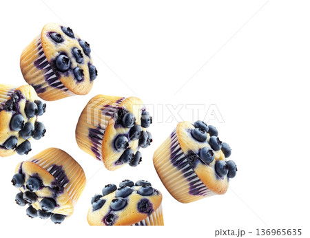 Multiple fresh blueberry muffins in scattered arrangement, isolated on white background. Concept of tasty homemade baking 136965635
