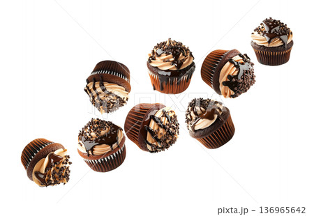 Chocolate cupcakes with creamy frosting and chocolate drizzle, isolated on white background, concept of dessert and sweets Chocolate cupcakes with creamy frosting and chocolate drizzle, isolated on white background, concept of dessert and sweets 136965642