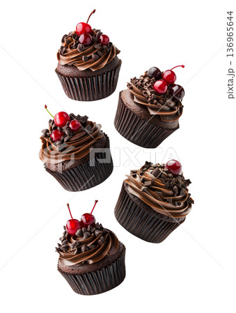 Multiple chocolate cupcakes with swirled frosting, cherries, and sprinkles on white background, concept of dessert variety 136965644