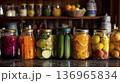 Luminous Mason Jars Filled With Citrus Segments And Cucumber Pickles Arranged On Kitchen Surface 136965834