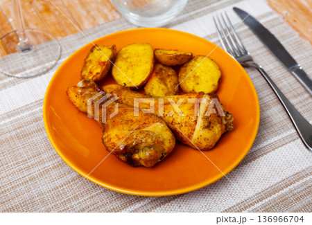Barbecued chicken leg with boiled potatoes closeup on plate Barbecued chicken leg with boiled potatoes closeup on plate 136966704