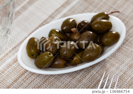 Pickled green olives in bowl on table Pickled green olives in bowl on table 136966754