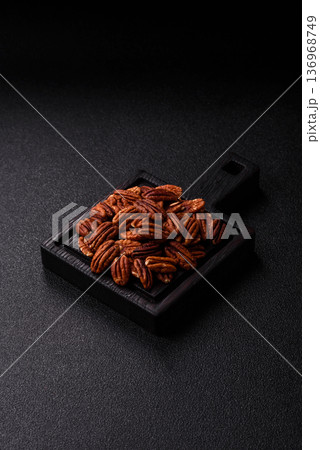 Peeled and roasted pecan nut as an ingredient for healthy food. Pecan nut as a food background 136968749