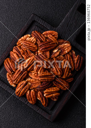 Peeled and roasted pecan nut as an ingredient for healthy food. Pecan nut as a food background Peeled and roasted pecan nut as an ingredient for healthy food. Pecan nut as a food background 136968752