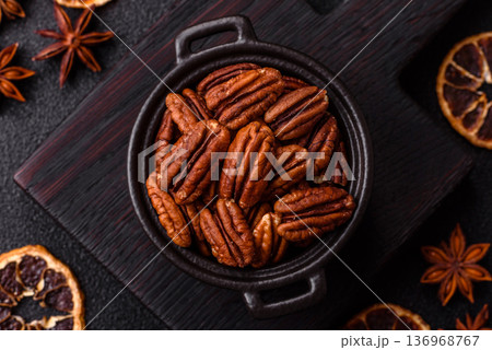 Peeled and roasted pecan nut as an ingredient for healthy food. Pecan nut as a food background 136968767