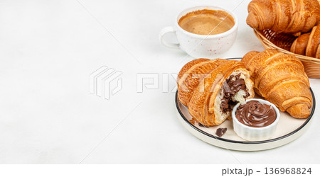 Chocolate croissants with coffee and cocoa spread on white background Chocolate croissants with coffee and cocoa spread on white background 136968824