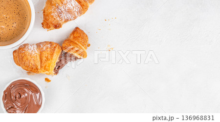 Chocolate croissants with coffee and copy space on white background top view Chocolate croissants with coffee and copy space on white background top view 136968831