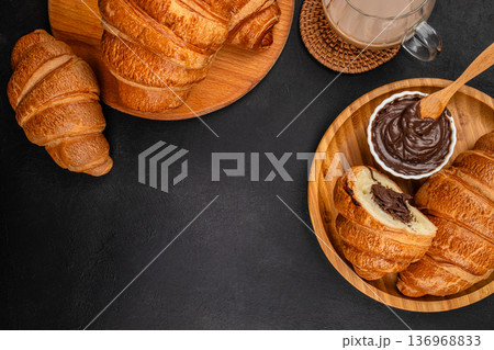 Chocolate croissants with coffee and copy space on dark background 136968833