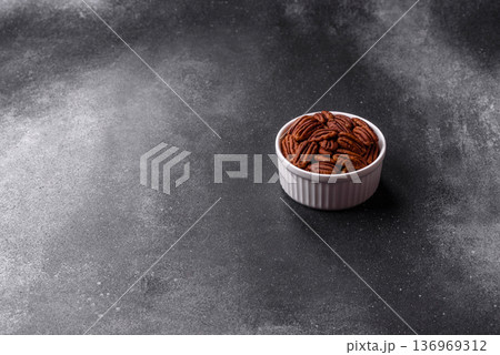 Peeled and roasted pecan nut as an ingredient for healthy food. Pecan nut as a food background 136969312
