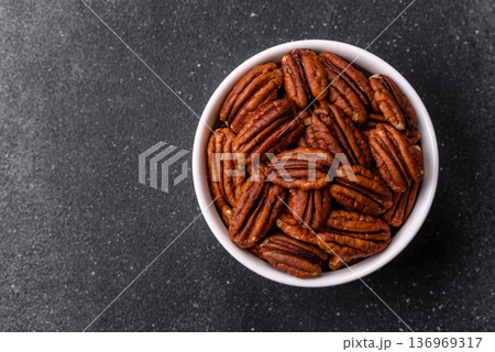 Peeled and roasted pecan nut as an ingredient for healthy food. Pecan nut as a food background 136969317