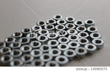 Pattern of nuts lie on a white surface tightly fitted to each other 136969575