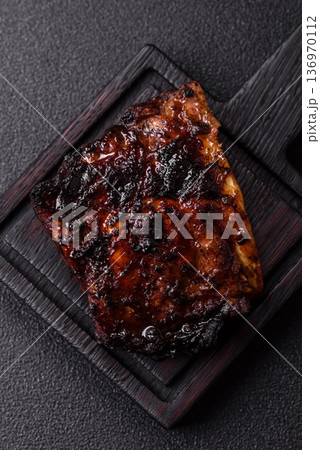 Grilled or barbecued pork or beef ribs, meat with red sauce for the dinner table. Grilled ribs 136970112