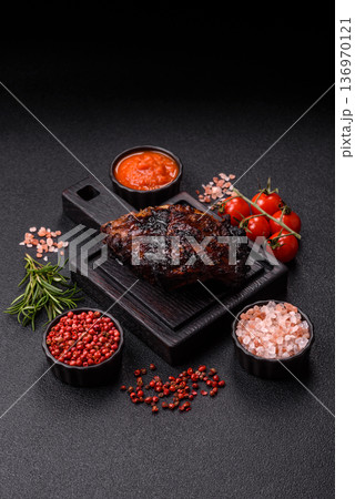 Grilled or barbecued pork or beef ribs, meat with red sauce for the dinner table. Grilled ribs 136970121