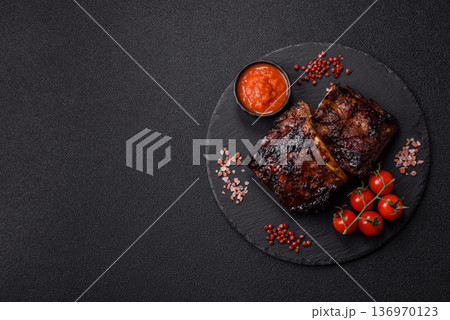 Grilled or barbecued pork or beef ribs, meat with red sauce for the dinner table. Grilled ribs 136970123