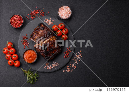 Grilled or barbecued pork or beef ribs, meat with red sauce for the dinner table. Grilled ribs 136970135