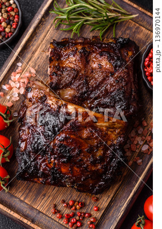 Grilled or barbecued pork or beef ribs, meat with red sauce for the dinner table. Grilled ribs Grilled or barbecued pork or beef ribs, meat with red sauce for the dinner table. Grilled ribs 136970144