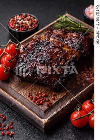Grilled or barbecued pork or beef ribs, meat with red sauce for the dinner table. Grilled ribs 136970145