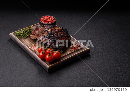 Grilled or barbecued pork or beef ribs, meat with red sauce for the dinner table. Grilled ribs 136970150