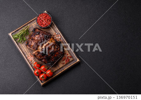 Grilled or barbecued pork or beef ribs, meat with red sauce for the dinner table. Grilled ribs 136970151