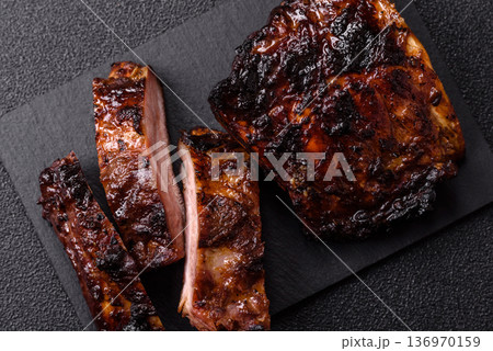 Grilled or barbecued pork or beef ribs, meat with red sauce for the dinner table. Grilled ribs 136970159
