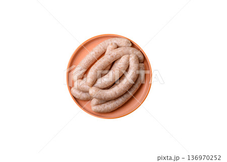 Raw pork or chicken meat sausages for grilling, a spicy picnic food. Raw sausages Raw pork or chicken meat sausages for grilling, a spicy picnic food. Raw sausages 136970252
