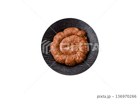 Grilled sausage in the shape of a spiral or snail, from chicken or pork. Spiral or snail sausage 136970266