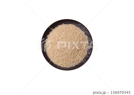 White sesame seeds in a bowl, an ingredient for oil and healthy eating. White sesame 136970345